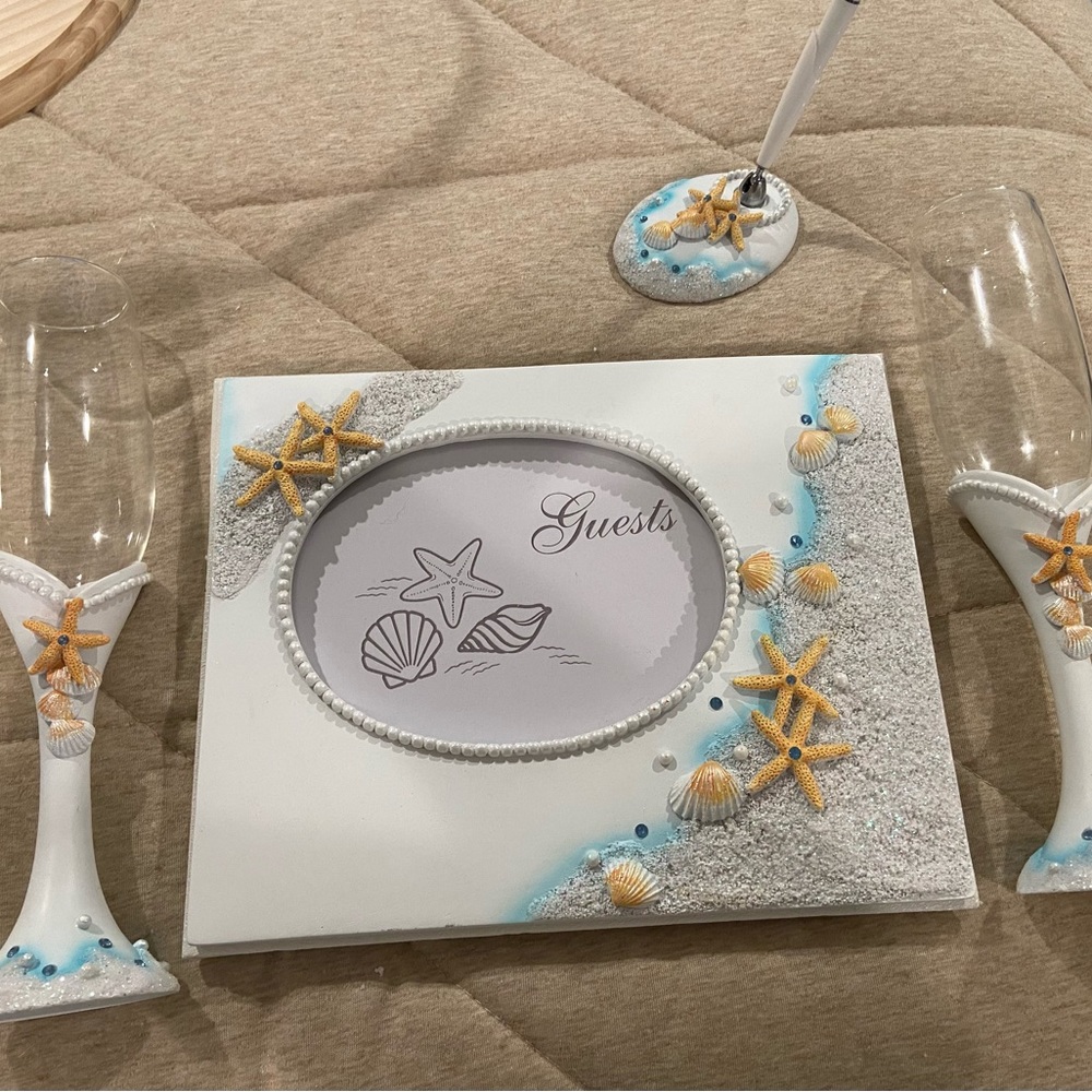 Beach theme‎ guest book, pen, goblets and matching cake cutters.